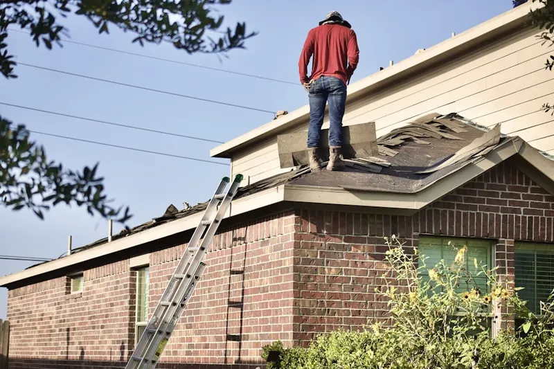 Professional roofer working on a residential roof in Montague Village